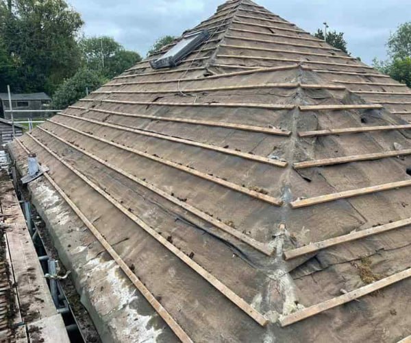 This is a photo of a hip roof that has been stripped back to the battens, and is awaiting a new roof covering to be installed. Works carried out by KLJ Roofing Towcester